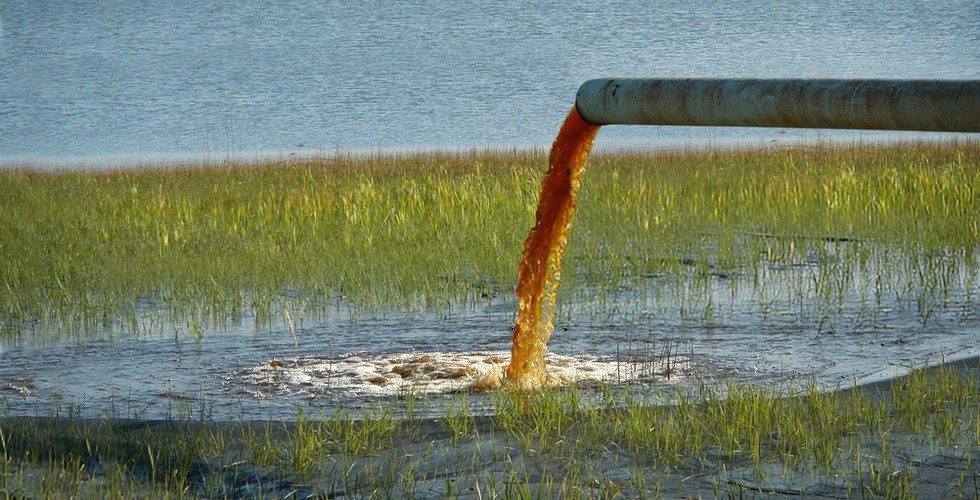 Toxic wastewater being pumped into a body of fresh water.