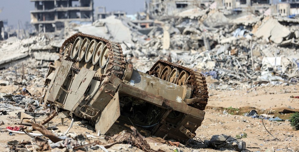 Close up of destroyed Gaza. An upturned tank is visible in the foreground.
