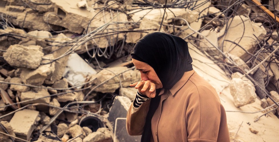 A Palestinian woman observes the wreckage in her home in the West Bank